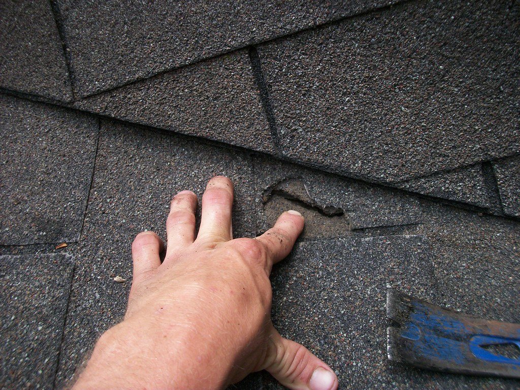 Roofing Contractor Preforming A Roofing Inspection